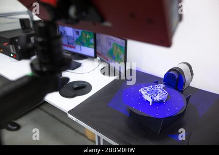 Professional 3D scanner scanning an industrial object plastic molding placed on a turntable, metrology concept Stock Photo