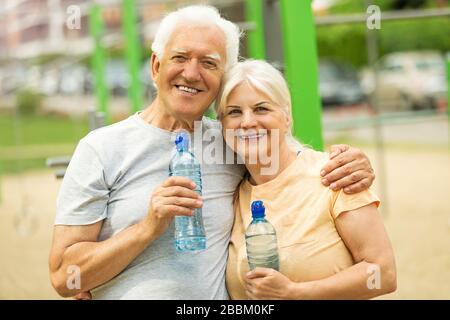 Senior Couple Exercising In Park Stock Photo