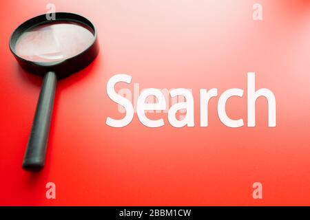Word search written on red background and  magnifying glass next to it Stock Photo