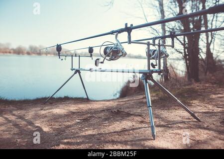 Spinning rods on a professional fishing rod stand outdoors Stock Photo -  Alamy