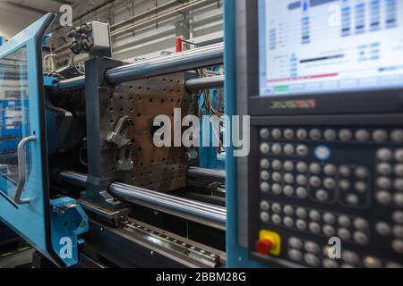 Huge injection molding machine without fixture, ready for the plastic articles by injecting heated material into mold Stock Photo