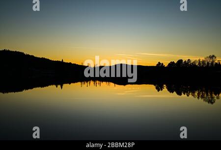 Sunset on an Autumnal evening on a lake in Vermont, New England, USA Stock Photo