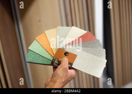 Man chossing floor from the sampler for his new apartment, household furnishing Stock Photo