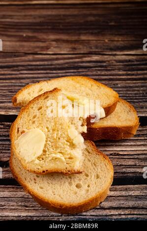 Fresh wheat toast with butter on a wooden background. Close up Stock Photo