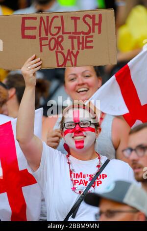 An England fan in the stands holds up a scarf celebrating England's ...