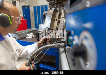 Engineer doing maintenance on a injection mold for plastic components, industrial and automotive concept Stock Photo