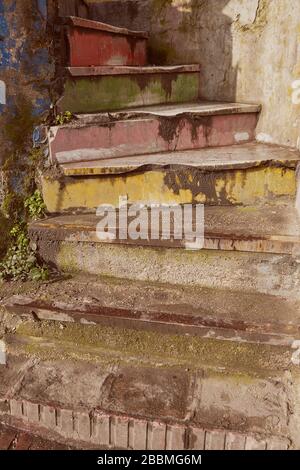 Concrete rainbow spiral staircase with faded shabby paint, Istanbul, Turkey. Stock Photo