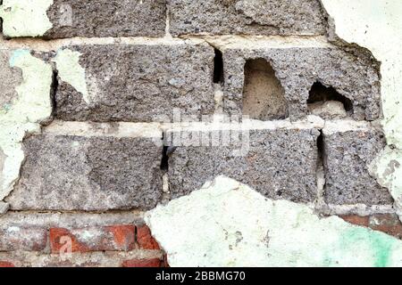 Texture of gray concrete wall with broken green stucco, abstract image for background, or backdrop. Stock Photo