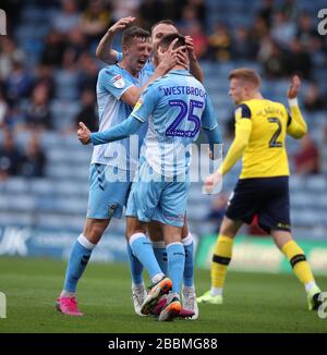 Coventry City 's Zain Westbrooke celebrates with team mates after scoring his side's first goal from a free kick during the Sky Bet League One match at the Kassam Stadium Oxford. Stock Photo