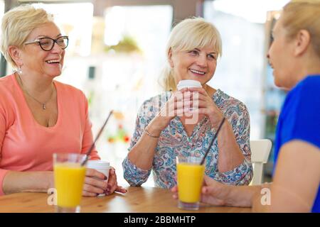 Group of smiling senior women standing outside Stock Photo