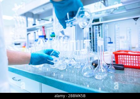Professional female chemist researcher carrying out scientific research in a lab, industrial concept