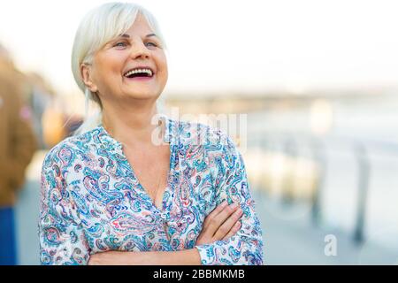 Senior woman standing outdoors Stock Photo