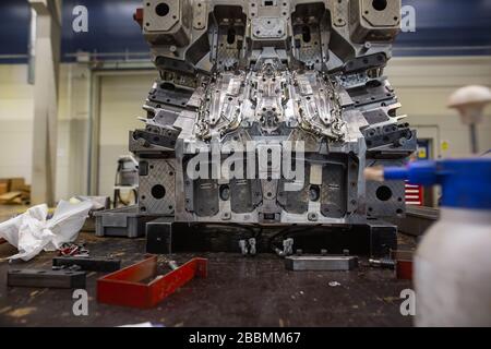 injection mold under maintenance with huge arrenge of maintenance equipment, industrial concept Stock Photo