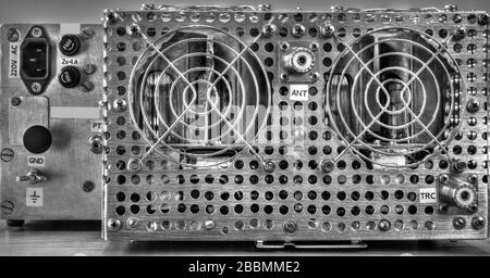 Close up view of a rear panel of a high frequency power amplifier with vacuum tubes in black and white Stock Photo