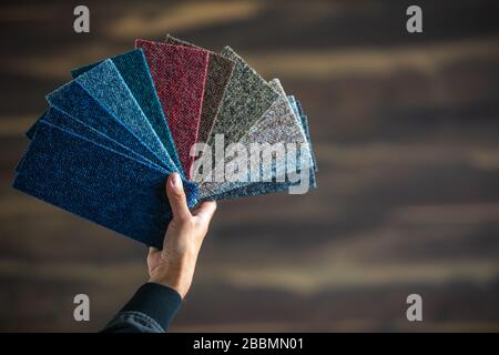 Man chossing floor from the sampler for his new apartment, household furnishing Stock Photo
