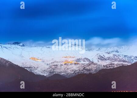 A distant view of the Ski villages over Santiago in the Andes Mountain Range Stock Photo