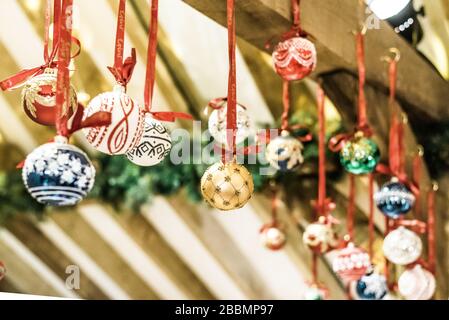 Multi coloured handmade Christmas baubles hanging in a stall in England Stock Photo