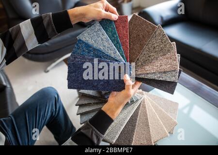 Man chossing floor from the sampler for his new apartment, household furnishing Stock Photo