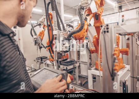 Engineer, technician working with automatic robot in automotive industrial, smart factory, automated workplace Stock Photo