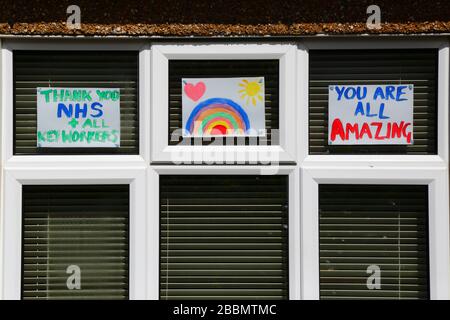 1st April 2020, Southborough, Kent, UK: Child's drawing of a rainbow with thank you messages for NHS staff and key workers in window of a house during the government imposed quarantine / lockdown to reduce the spread of the coronavirus. Children across the country have been putting drawings of rainbows in windows to spread hope and encourage people to stay cheerful during the pandemic. Stock Photo