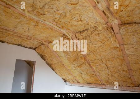 Glass wool on the roof of the new house, ready for plasterboard, industrial concept Stock Photo