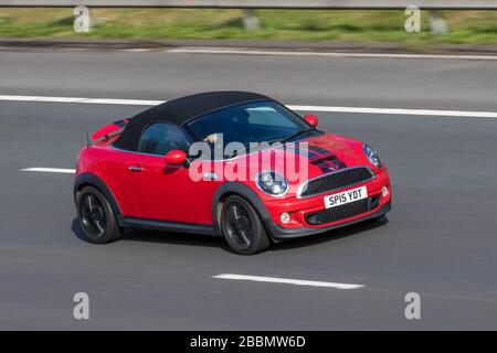 2015 red Mini Mini Roadster Cooper S; Vehicular traffic moving vehicles, vehicle driving, roads, motors, motoring on the M6 motorway highway Stock Photo