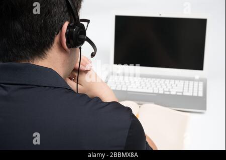 Online learning concept. A man who is receiving online learning using a laptop. Stock Photo