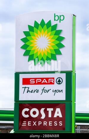 Filling station sign indicating BP fuel, an in store SPAr shop and Costa Coffee express cafe Stock Photo