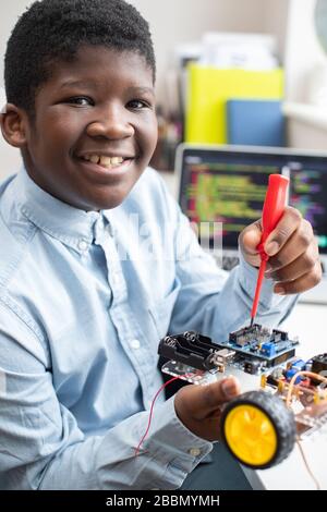 Portrait Of Male High School Pupil Building Robot Car In Science Lesson Stock Photo