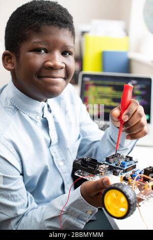Portrait Of Male High School Pupil Building Robot Car In Science Lesson Stock Photo