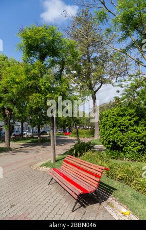 Red  bench in park, Silves, Algarve, Portugal Stock Photo