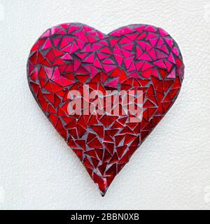 Crackled mosaic heart decoration on a white background, England Stock Photo