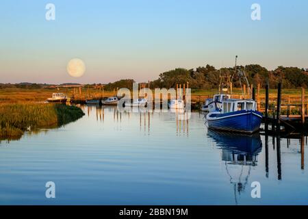 Moon rising over boat house in Thornham, Norfolk, England Stock Photo