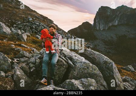 Father hiking with baby adventurous family travel vacations trip in mountains happy smiling man with child together outdoor recreation summer healthy Stock Photo