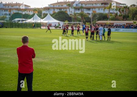 football coach watching his team in the preparation for a football match Stock Photo