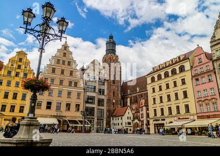 St Elizabeth's church tower and the tiny but well-known Hansel and Gretal house beneath it, from the rynek market square, Wroclaw, Poland. July 2017. Stock Photo