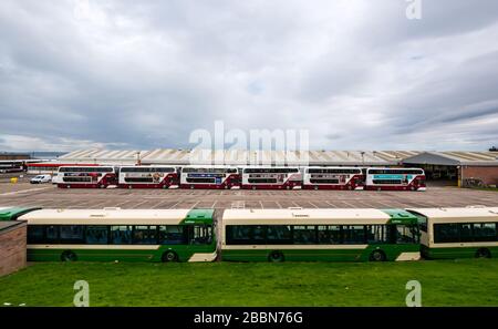 Edinburgh, Scotland, United Kingdom. 1st April 2020. Covid-19 Lockdown: With the significant reduction in bus services during the Coronavirus pandemic, the Lothian bus depot at Seafield is shut down with large numbers of buses parked in lines Stock Photo