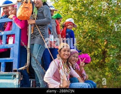 Myanmarese women workers on the back of truck(s) being transported often long distances to work in Chinese owned factories in Myanmar (formerly Burma) Stock Photo