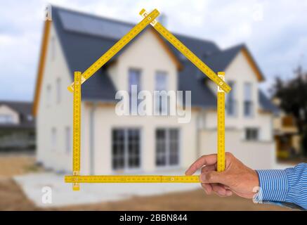 Real estate agent presents a newly built house for purchase Stock Photo