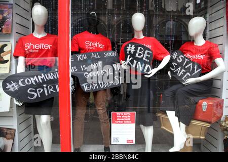 A message in the window of the charity shop Shelter in Glasgow as the UK continues in lockdown to help curb the spread of the coronavirus. Stock Photo