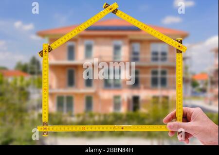 Real estate agent presents a newly built house for purchase Stock Photo