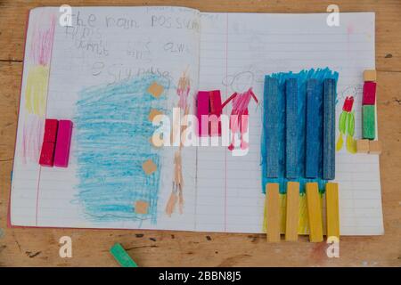 1st April 2020 Vintage Cuisenaire wooden counting rods and accompanying schoolbook maths challenges Stock Photo