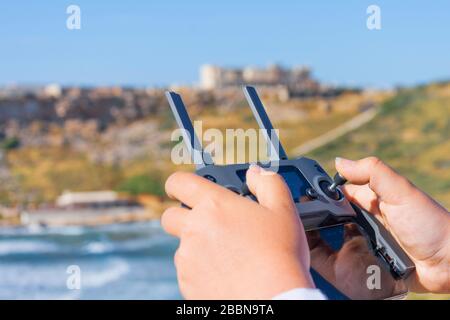 Hands of a girl holding a remote control for a flying drone Stock Photo