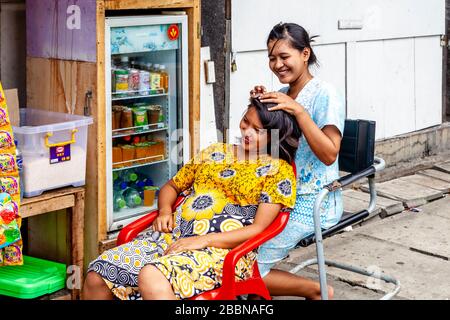 Two Young Indonesian Women Grooming Hair In The Old Town, Jakarta, Indonesia. Stock Photo