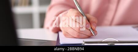 Closeup, female hands taking notes with pen office Stock Photo