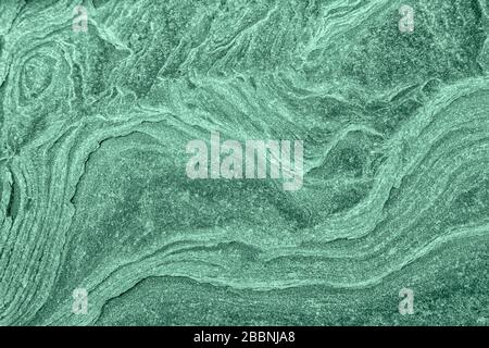 Stone textured background with roughness toned in neo mint color. Background for design or product. Stock Photo