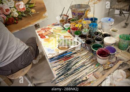 Young woman painter in golden frame with color pallet and paint brush ...