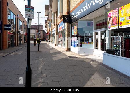 Huntingdon Town Centre, Cambridgeshire on lockdown. Deserted town centre with very few people on the streets of the town centre. Usually a very busy and vibrant town centre people are following Covid-19 coronavirus advice to stay at home avoiding unnecessary travel. Shops are all closed. Stock Photo