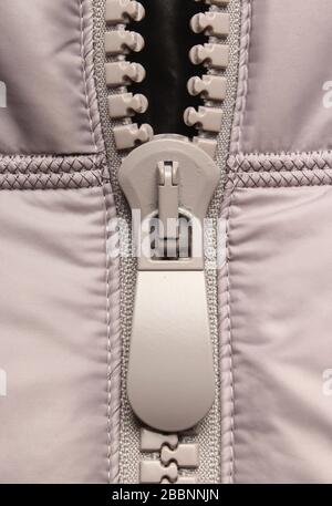 Gray plastic zipper on closes Stock Photo