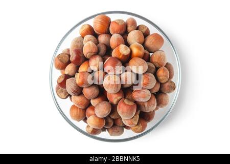 Hazelnuts in a glass cup isolated on white Stock Photo